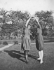 Two Girls Frolicking in Yard